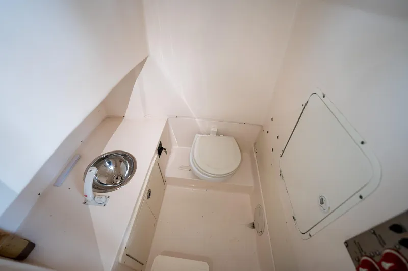 Slide: The Image of 2007 Sea Hunt Triton 290 boat bathroom with toilet and sink. - 37