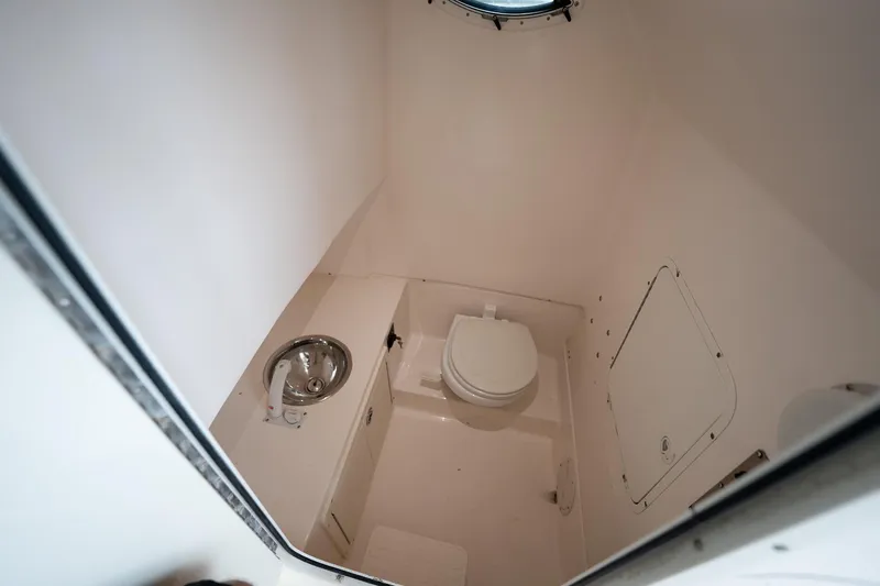 Slide: The Image of 2007 Sea Hunt Triton 290 boat bathroom with toilet and sink. - 38