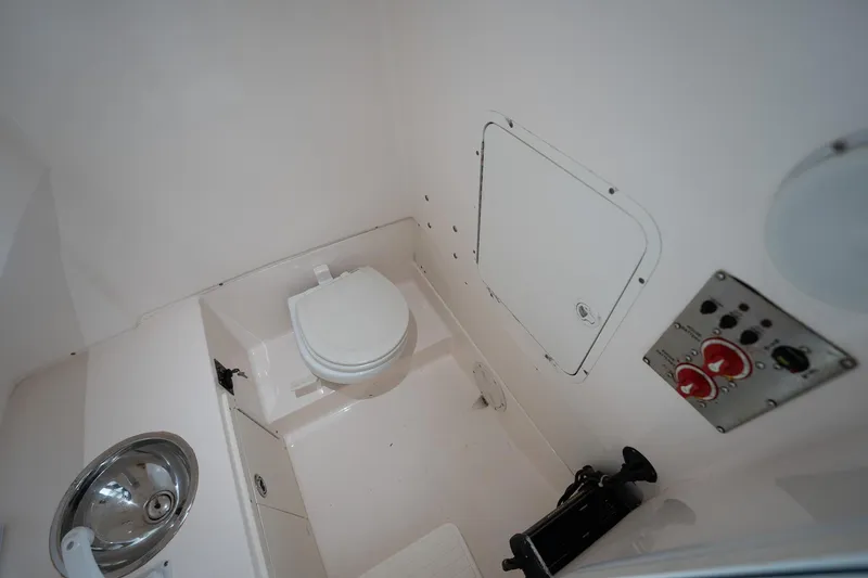 Slide: The Image of 2007 Sea Hunt Triton 290 boat interior with toilet, sink, and control panel. - 39