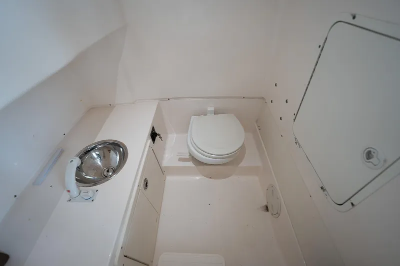 Slide: The Image of 2007 Sea Hunt Triton 290 boat bathroom with toilet and sink. - 40
