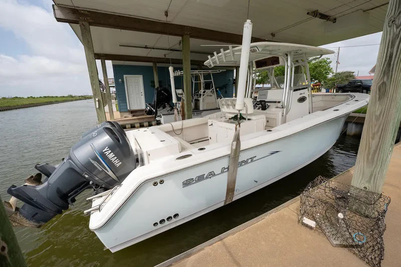 Slide: The Image of 2007 Sea Hunt Triton 290 boat docked with Yamaha outboard motor. - 6