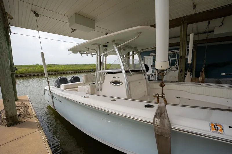 Slide: The Image of 2007 Sea Hunt Triton 290 boat docked in a covered marina. - 8