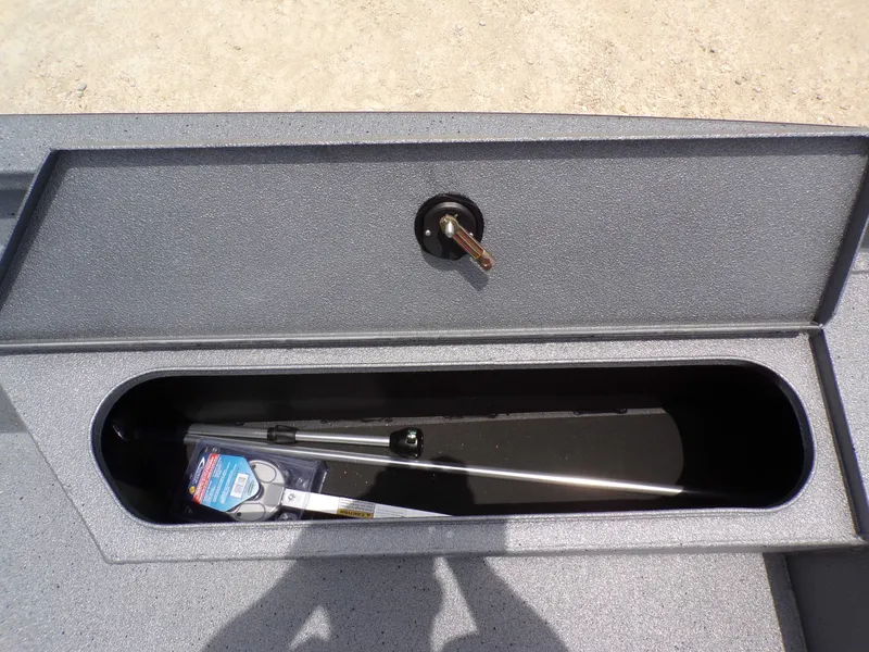 Slide: The Image of Xpress SW22B 2026 boat storage compartment with tools. - 26