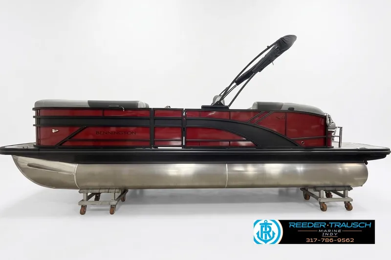 The Image of 2026 Bennington 21 SSB pontoon boat with red and black design on display. - 1