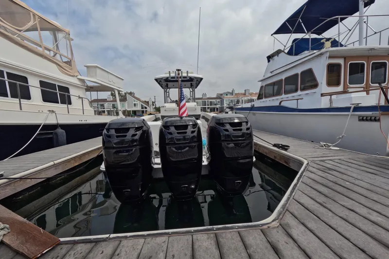 Slide: The Image of 2011 Donzi 38 ZFX Open with four outboard motors docked between boats. - 17