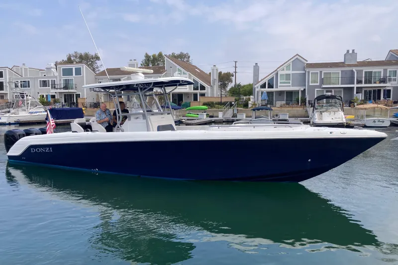 Slide: The Image of 2011 Donzi 38 ZFX Open boat docked in a marina, featuring sleek design and modern amenities. - 2