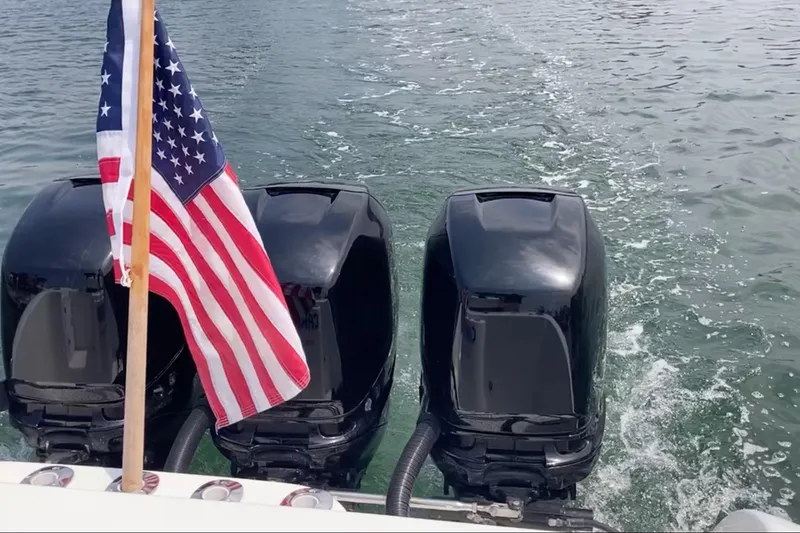 Slide: The Image of 2011 Donzi 38 ZFX Open with triple engines and American flag on water. - 22