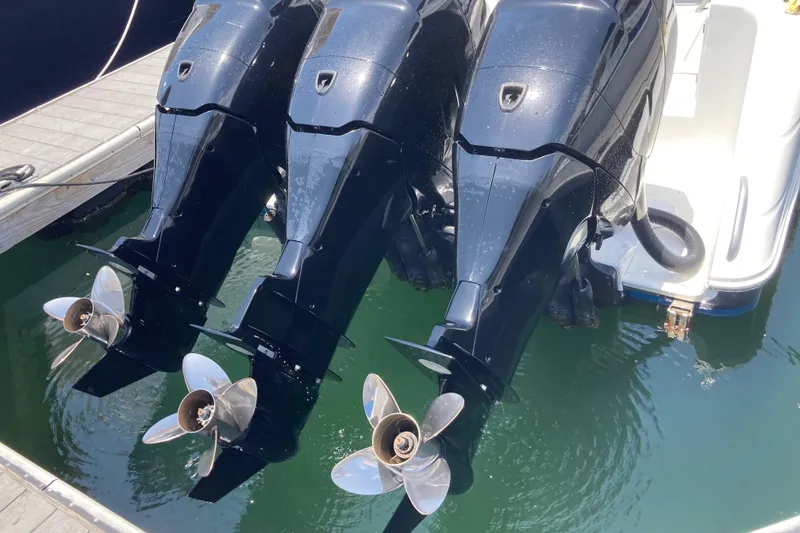 Slide: The Image of Triple outboard motors on a 2011 Donzi 38 ZFX Open boat at a dock. - 23