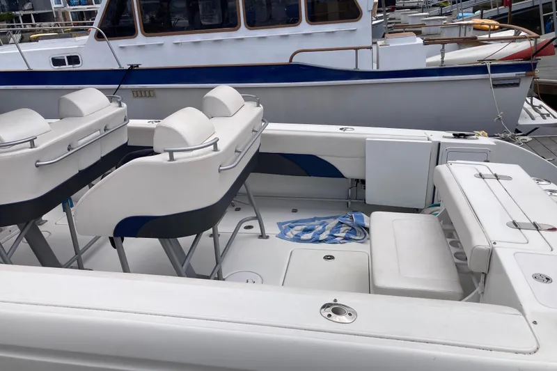 Slide: The Image of 2011 Donzi 38 ZFX Open boat interior with seating and striped towel. - 26