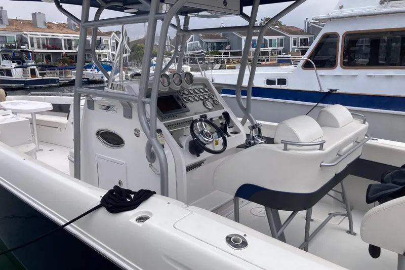 Slide: The Image of 2011 Donzi 38 ZFX Open boat interior with helm and seating in marina. - 27