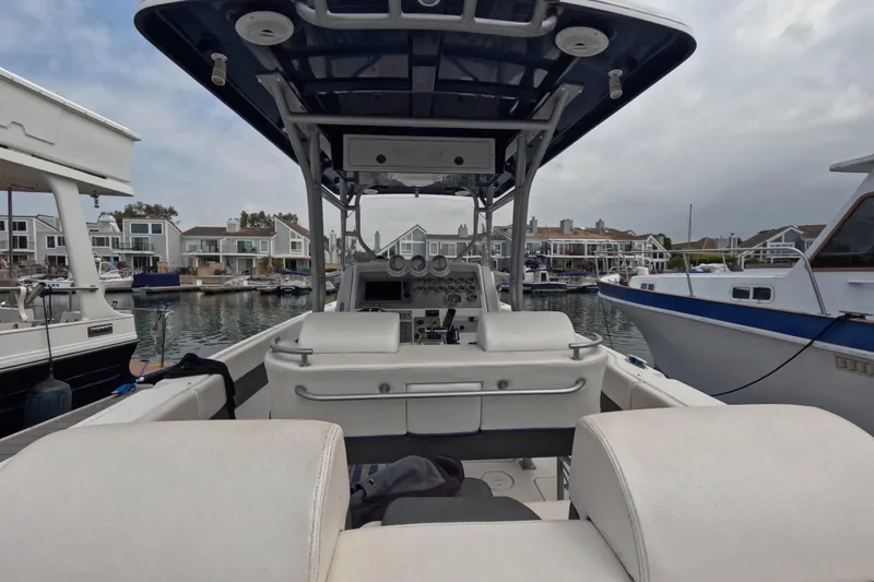 Slide: The Image of 2011 Donzi 38 ZFX Open boat interior at marina, showcasing helm and seating. - 28