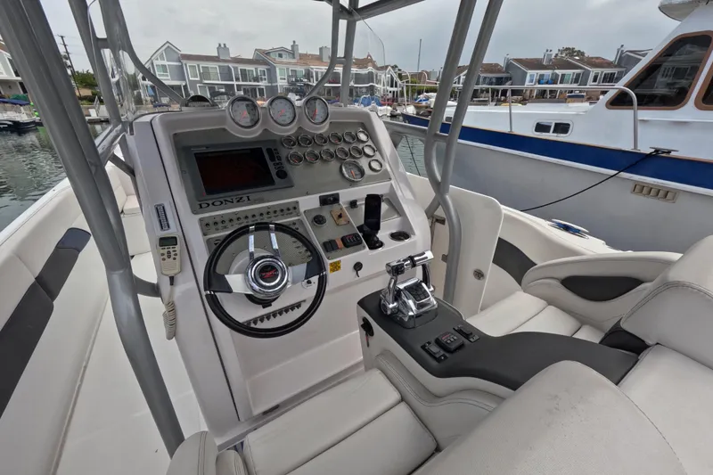 Slide: The Image of Cockpit of 2011 Donzi 38 ZFX Open boat with steering wheel and control panel. - 29