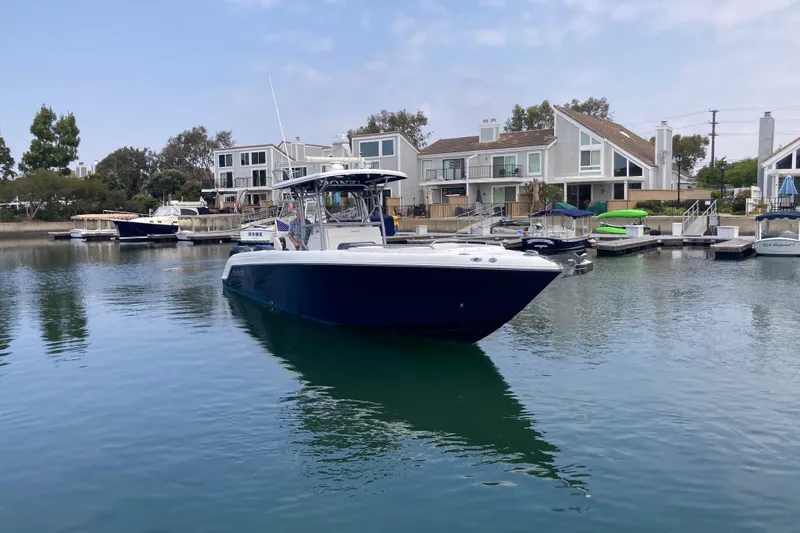 The Image of 2011 Donzi 38 ZFX Open boat docked in a serene marina setting. - 3