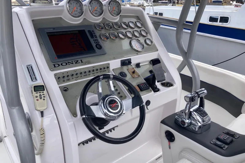 Slide: The Image of Control panel of a 2011 Donzi 38 ZFX Open boat with steering wheel and gauges. - 30