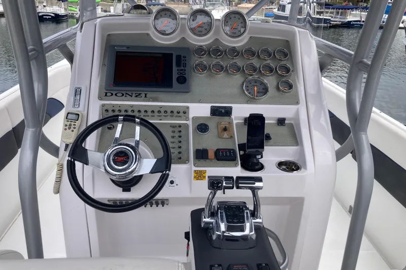 Slide: The Image of Cockpit of 2011 Donzi 38 ZFX Open boat with steering wheel and gauges. - 31
