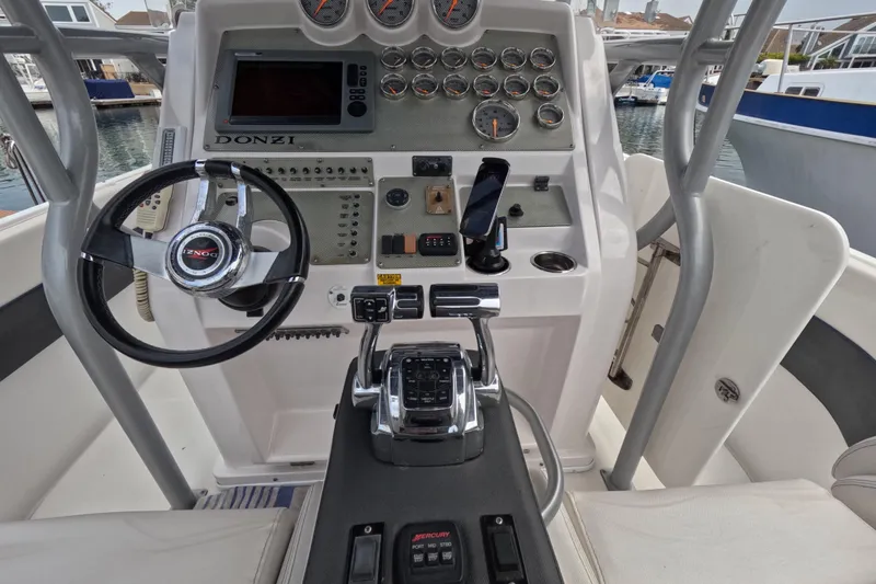 Slide: The Image of Cockpit view of a 2011 Donzi 38 ZFX Open boat with steering wheel and controls. - 32