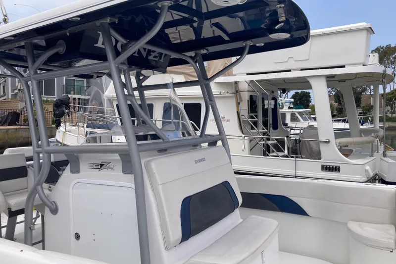 Slide: The Image of 2011 Donzi 38 ZFX Open boat docked, featuring sleek design and modern amenities. - 34