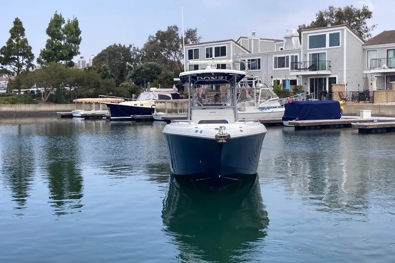 Slide: The Image of 2011 Donzi 38 ZFX Open boat docked in a serene marina setting. - 4