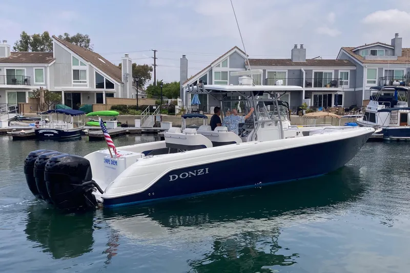 The Image of 2011 Donzi 38 ZFX Open boat docked near waterfront homes. - 0