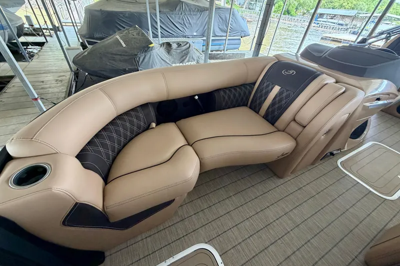 Slide: The Image of Luxurious seating on 2023 Barletta Lusso 23U pontoon boat, featuring tan upholstery and cup holders. - 13