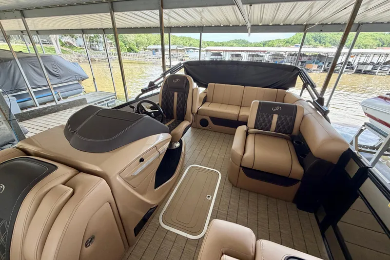 Slide: The Image of 2023 Barletta Lusso 23U pontoon boat interior with luxurious seating and helm. - 15