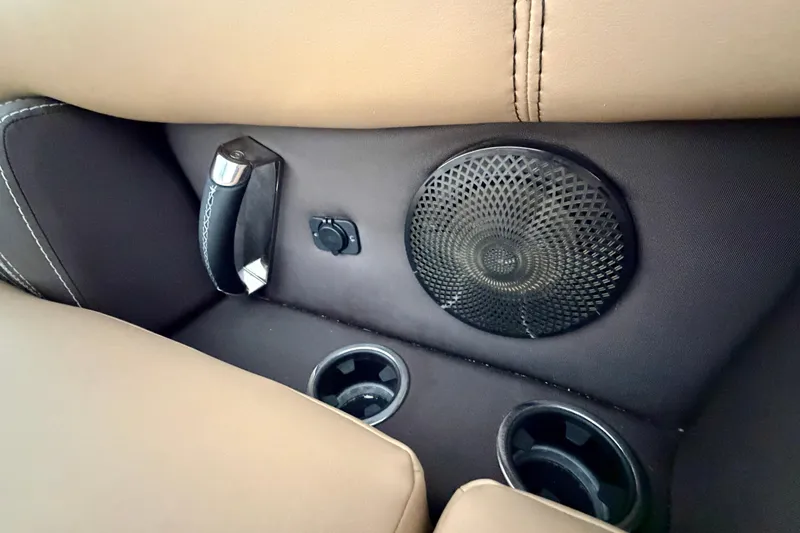 Slide: The Image of 2023 Barletta Lusso 23U interior features cup holders, speaker, and handle. - 16
