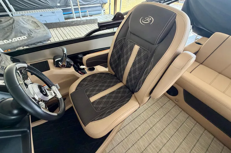 Slide: The Image of 2023 Barletta Lusso 23U captain's chair and steering wheel, featuring luxurious design and detailing. - 18