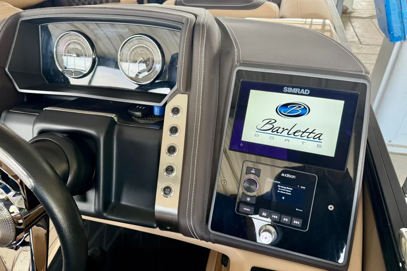 Slide: The Image of 2023 Barletta Lusso 23U dashboard featuring Simrad display and Audison controls. - 21