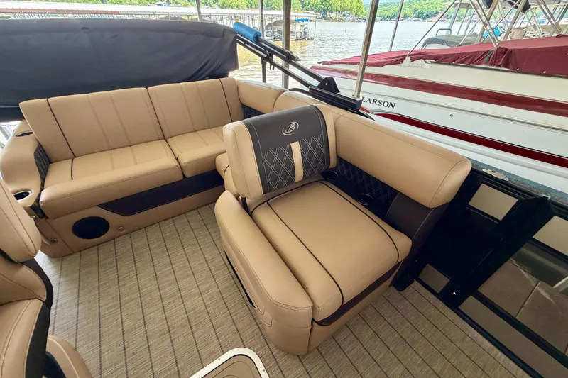 Slide: The Image of Luxurious seating on 2023 Barletta Lusso 23U pontoon boat, docked by the lake. - 24