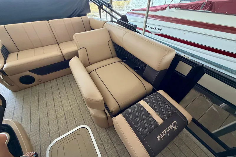 Slide: The Image of Luxurious interior of 2023 Barletta Lusso 23U pontoon boat with beige seating. - 25