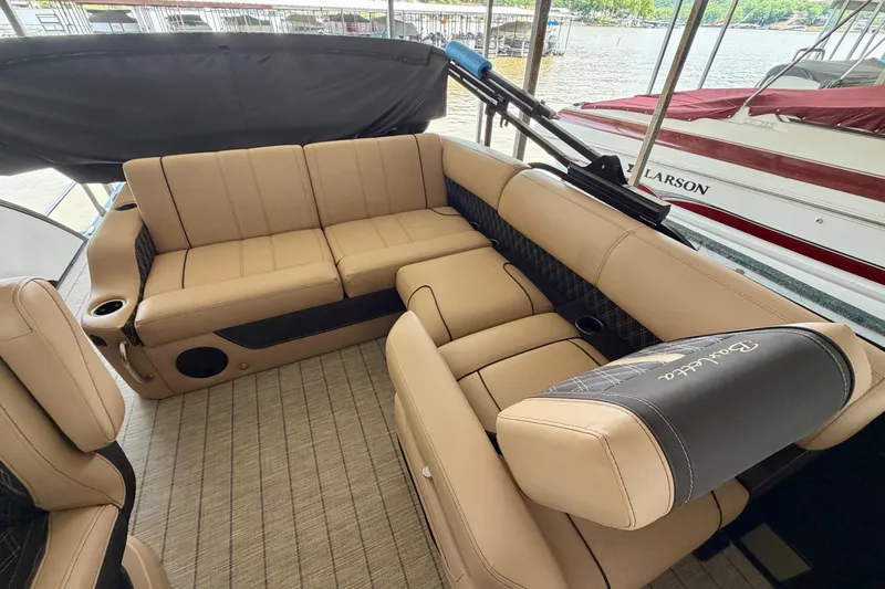 Slide: The Image of Luxurious seating on 2023 Barletta Lusso 23U pontoon boat, docked by the water. - 26