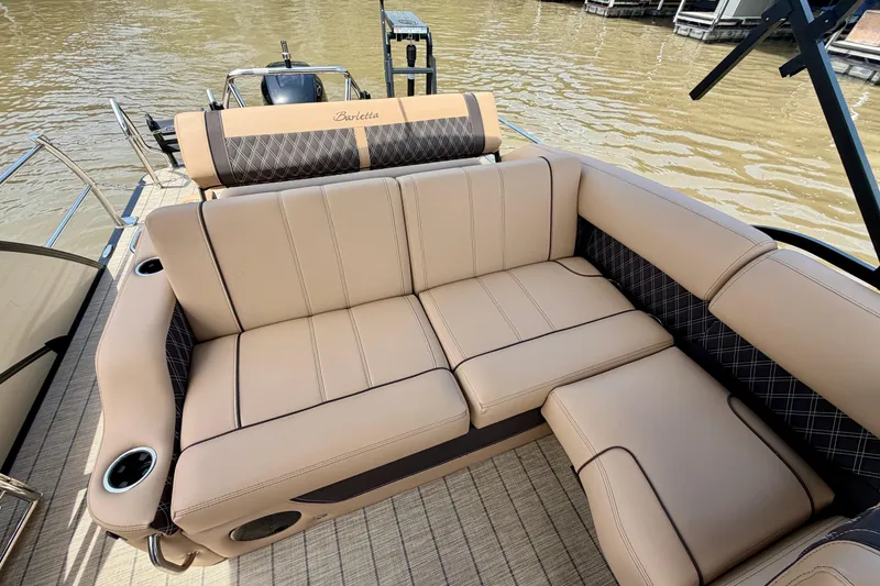 Slide: The Image of Luxurious seating on 2023 Barletta Lusso 23U pontoon boat, featuring beige upholstery and cup holders. - 29