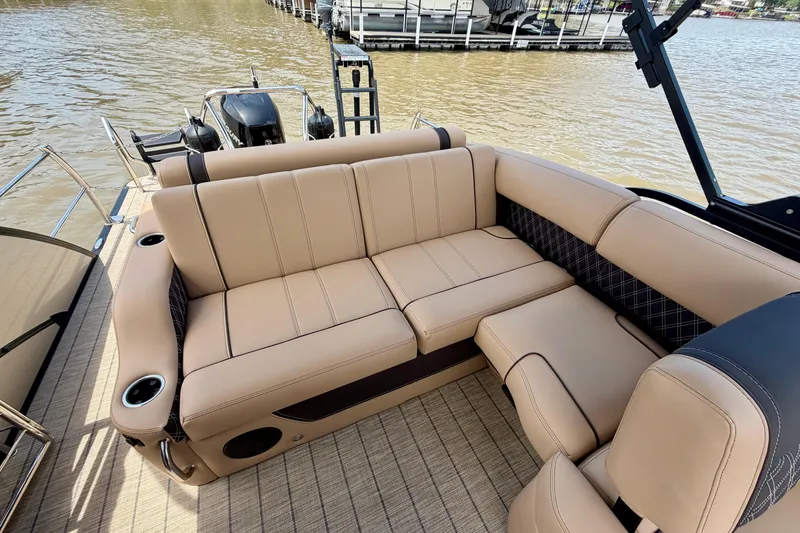Slide: The Image of Luxurious seating on 2023 Barletta Lusso 23U pontoon boat, docked by the water. - 30