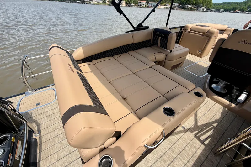 Slide: The Image of 2023 Barletta Lusso 23U pontoon boat with luxurious tan seating on a serene lake. - 32