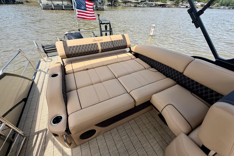 Slide: The Image of 2023 Barletta Lusso 23U pontoon boat with luxurious tan seating and American flag. - 33