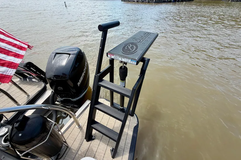 Slide: The Image of 2023 Barletta Lusso 23U boat with Mercury engine and swim ladder on a lake. - 38