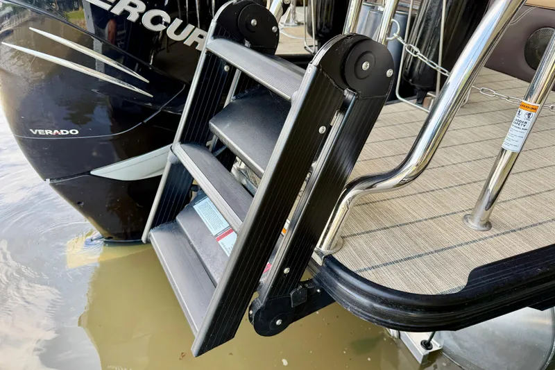 Slide: The Image of 2023 Barletta Lusso 23U boat ladder and deck, featuring a Mercury Verado engine. - 39