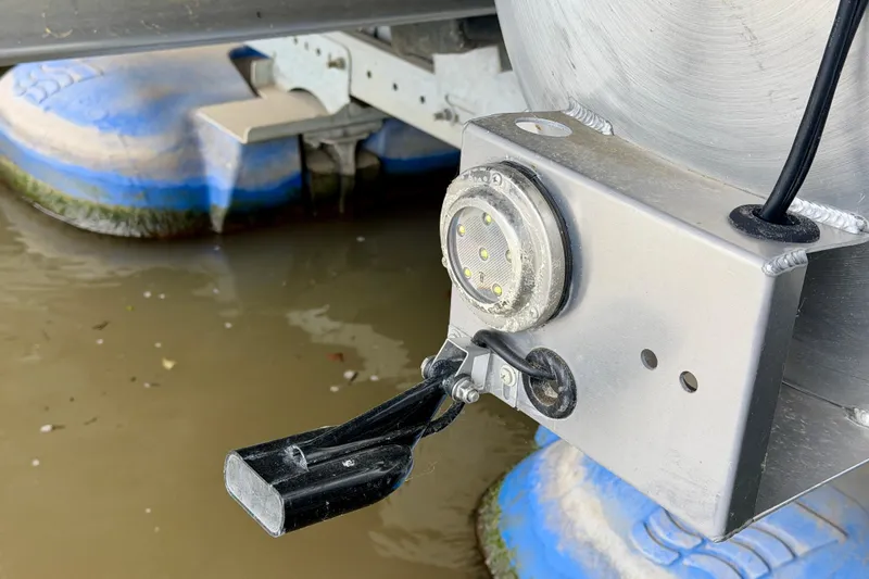 Slide: The Image of Close-up of Barletta Lusso 23U 2023 pontoon boat component near water. - 41