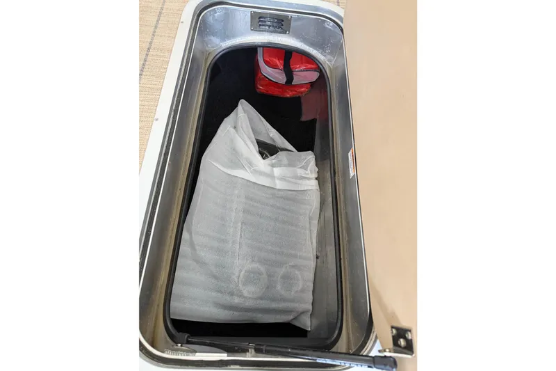 Slide: The Image of Storage compartment in 2023 Barletta Lusso 23U boat, containing a wrapped item. - 48