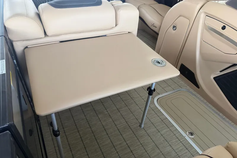 Slide: The Image of 2023 Barletta Lusso 23U interior with beige seating and foldable table. - 50
