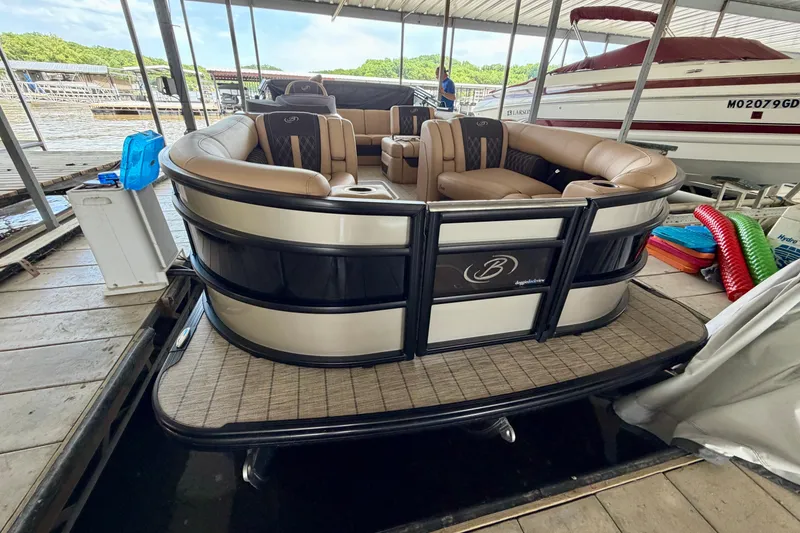 Slide: The Image of 2023 Barletta Lusso 23U pontoon boat docked, featuring luxurious seating and sleek design. - 6