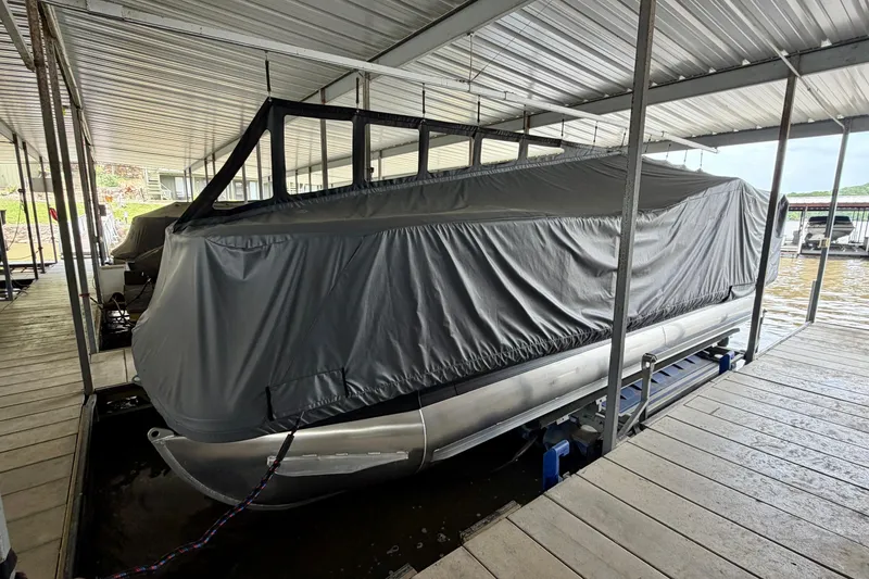 Slide: The Image of 2023 Barletta Lusso 23U pontoon boat covered in a docked marina. - 7