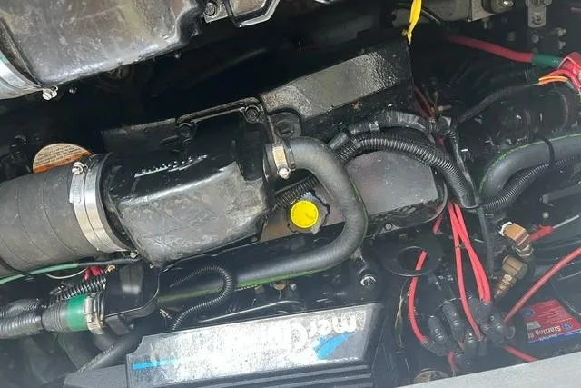 Slide: The Image of Engine compartment of a 1993 Sea Ray Sundancer 330 boat, showing various components and wiring. - 16