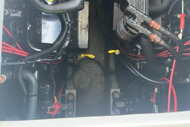 Slide: The Image of Engine compartment of a 1993 Sea Ray Sundancer 330 with visible wiring and components. - 18