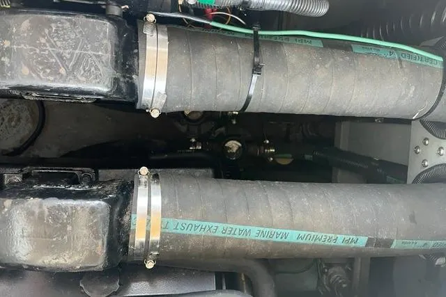 Slide: The Image of Engine compartment of a 1993 Sea Ray Sundancer 330 with marine water exhaust hoses. - 19