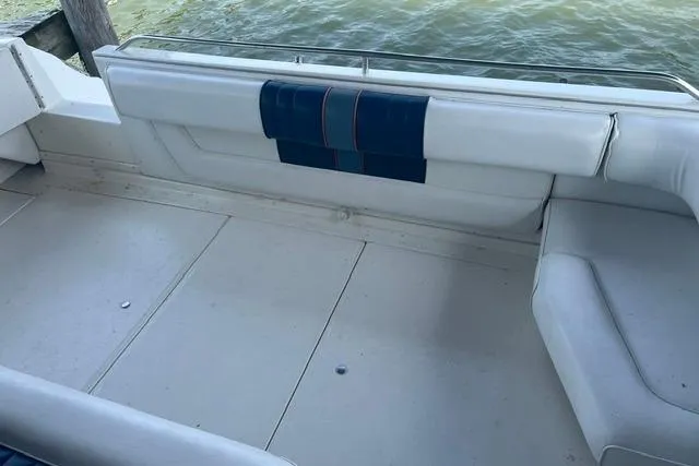 Slide: The Image of 1993 Sea Ray Sundancer 330 boat interior with white seating and blue accents. - 3