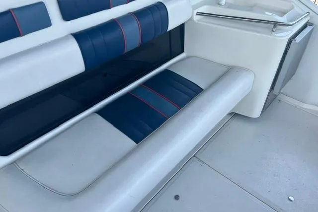 Slide: The Image of 1993 Sea Ray Sundancer 330 interior seating with blue and white upholstery. - 4