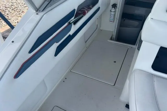Slide: The Image of 1993 Sea Ray Sundancer 330 interior with white seating and blue accents. - 5