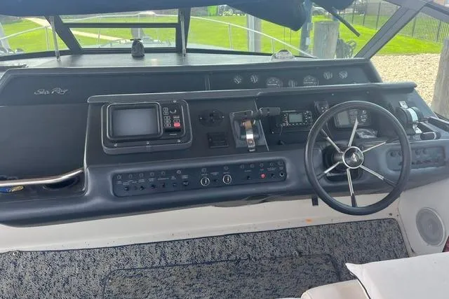 Slide: The Image of Cockpit of 1993 Sea Ray Sundancer 330 with steering wheel and navigation controls. - 6