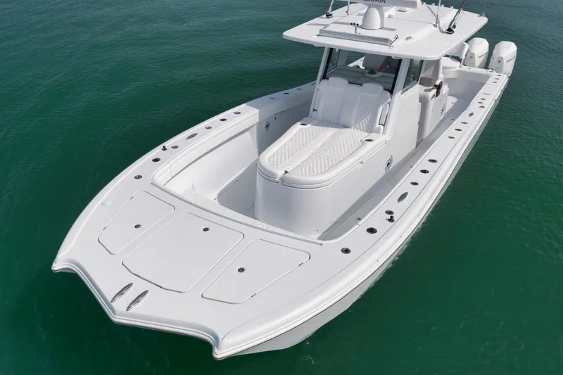 Slide: The Image of 2024 Costa Custom Boats 34SV, sleek white design on calm water. - 10